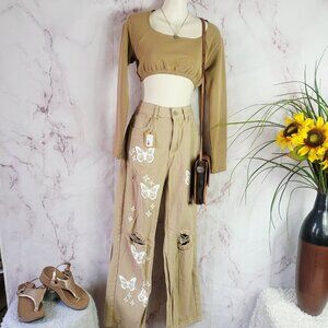 Butterfly embossed khaki jeans with intentional distressing